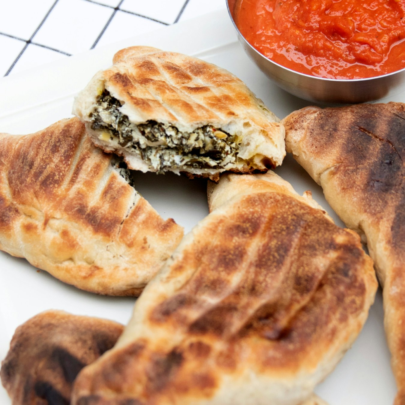 View item GRILLED SPINACH ARTICHOKE CALZONES