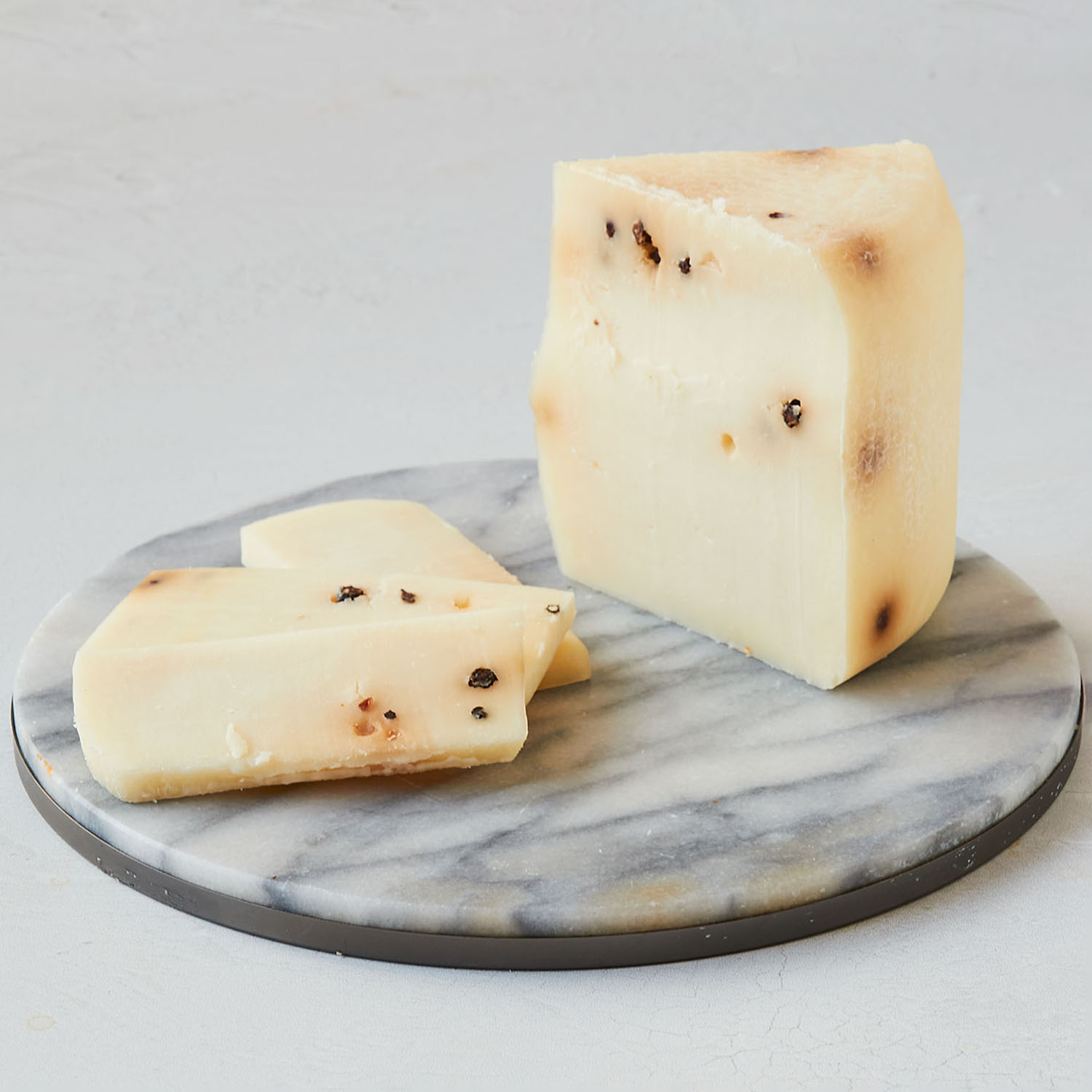 Rustico Black Pepper a smooth, mild sheep’s milk cheese with black
