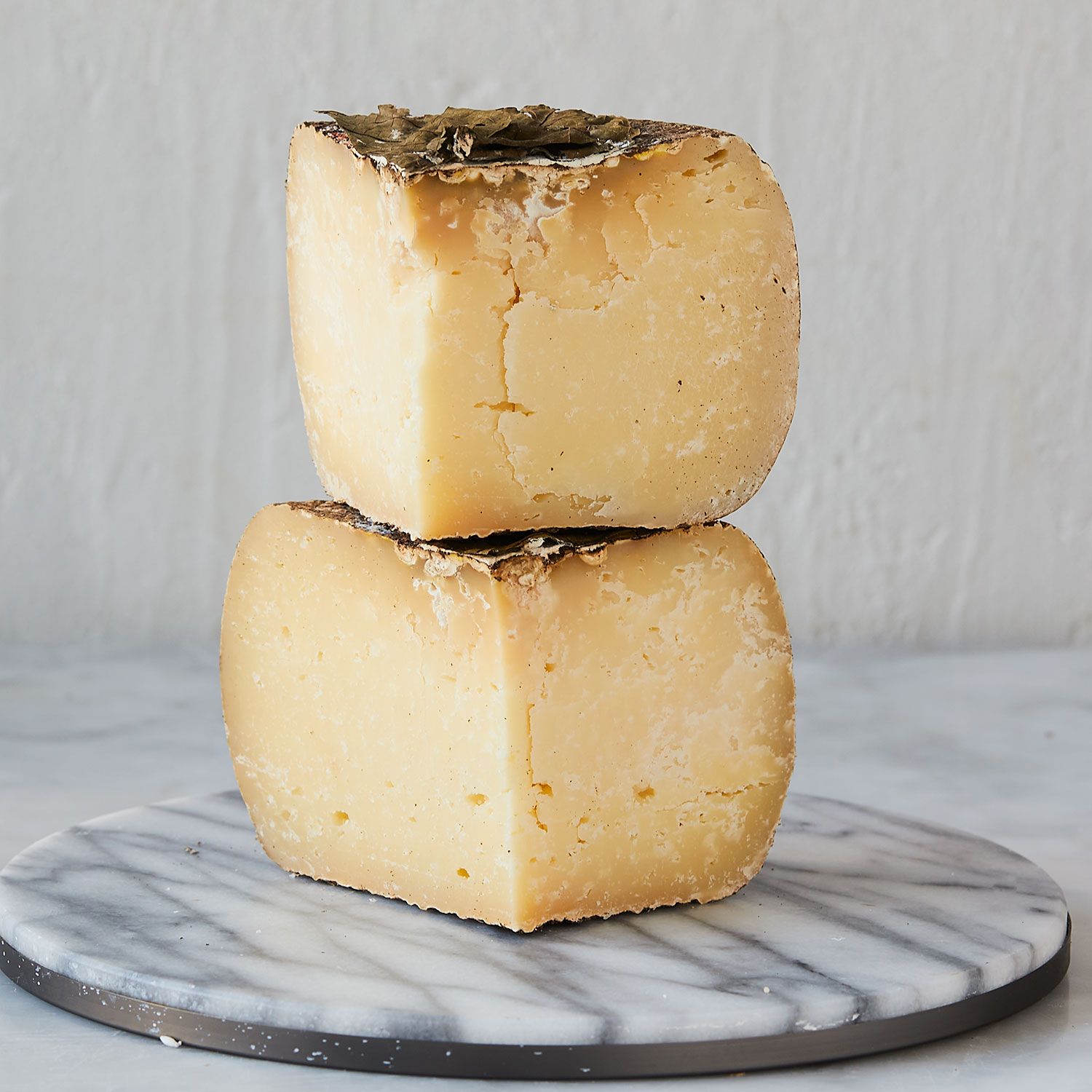 Pecorino Foglie di Noce a firm, earthy Italian cheese covered in